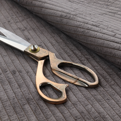 This fabric is a cool brown corduroy featuring a consistent vertical ribbed texture.