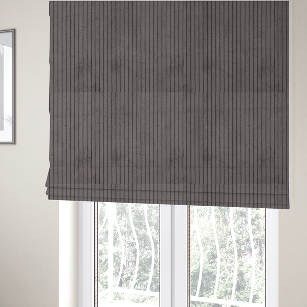 The fabric used to create these Roman blinds is a cool brown corduroy featuring a consistent vertical ribbed texture.