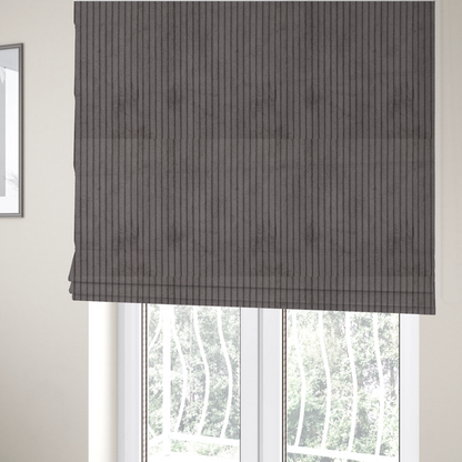 The fabric used to create these Roman blinds is a cool brown corduroy featuring a consistent vertical ribbed texture.