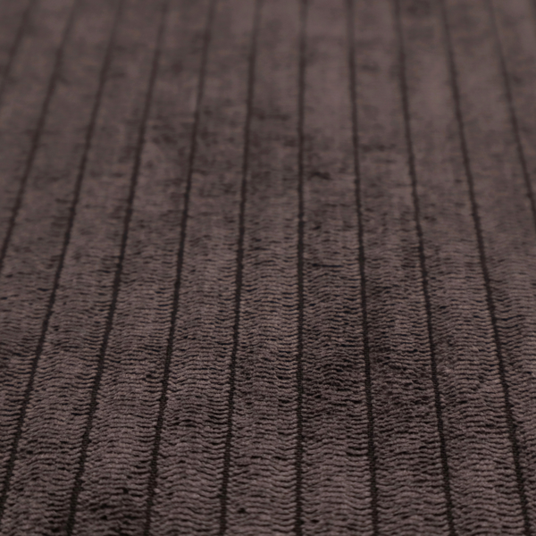 This fabric is a dark chocolate brown corduroy featuring a consistent vertical ribbed texture.