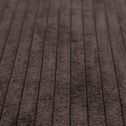 This fabric is a dark chocolate brown corduroy featuring a consistent vertical ribbed texture.