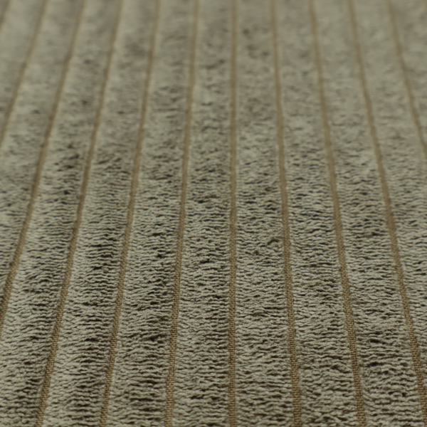 This fabric is an olive-green corduroy featuring a consistent vertical ribbed texture.