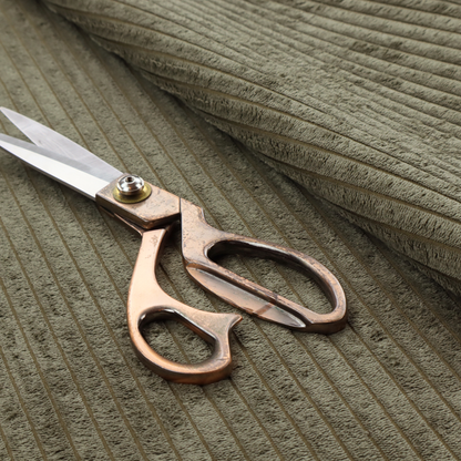 This fabric is an olive-green corduroy featuring a consistent vertical ribbed texture.