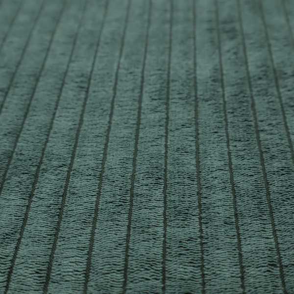 This fabric is a teal-green corduroy featuring a consistent vertical ribbed texture.