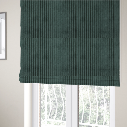 The fabric used to create these Roman blinds is a teal-green corduroy featuring a consistent vertical ribbed texture.