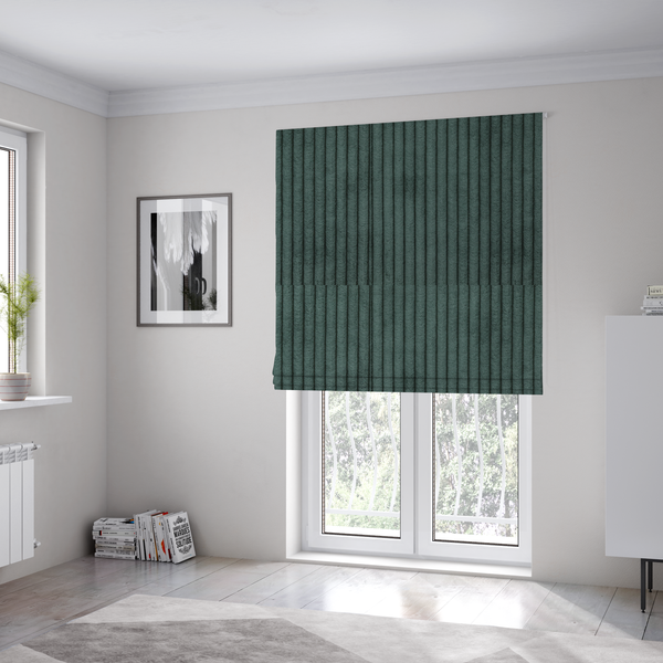 The fabric used to create these Roman blinds is a teal-green corduroy featuring a consistent vertical ribbed texture.