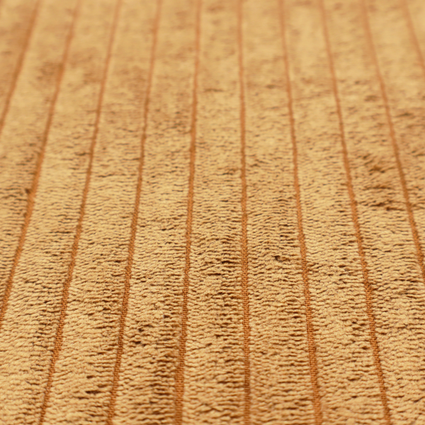 This fabric is a warm, golden-yellow or ochre corduroy featuring a consistent vertical ribbed texture.