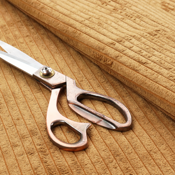 This fabric is a warm, golden-yellow or ochre corduroy featuring a consistent vertical ribbed texture.