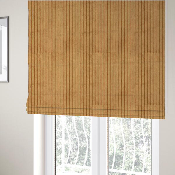 The fabric used to create these Roman blinds is a warm, golden-yellow or ochre corduroy featuring a consistent vertical ribbed texture.