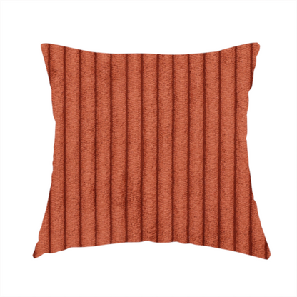 The fabric used to create this handmade cushion is a terracotta or burnt orange corduroy featuring a consistent vertical ribbed texture.