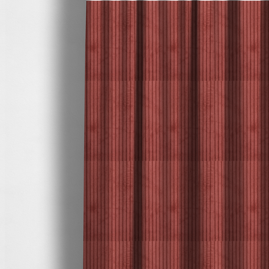 The fabric used to create these made-to-measure curtains is a brick red corduroy featuring a consistent vertical ribbed texture.