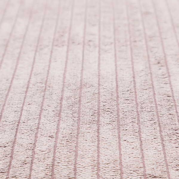 This fabric is a soft, dusty pink or blush-coloured corduroy featuring a consistent vertical ribbed texture.