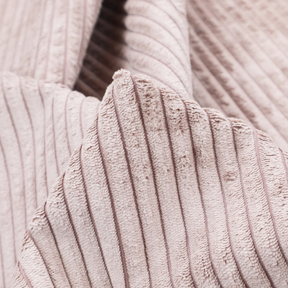 This fabric is a soft, dusty pink or blush-coloured corduroy featuring a consistent vertical ribbed texture.