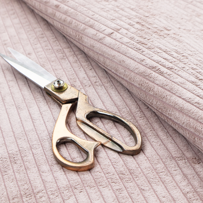 This fabric is a soft, dusty pink or blush-coloured corduroy featuring a consistent vertical ribbed texture.