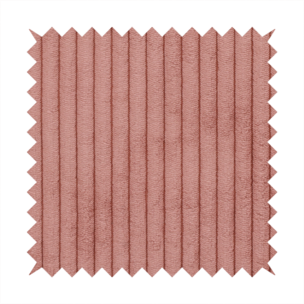 This fabric is a muted rose or dusty terracotta corduroy featuring a consistent vertical ribbed texture.