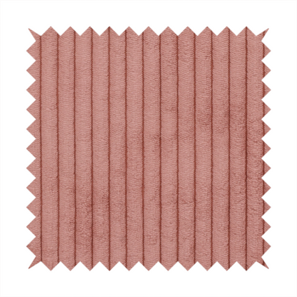 This fabric is a muted rose or dusty terracotta corduroy featuring a consistent vertical ribbed texture.