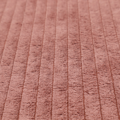 This fabric is a muted rose or dusty terracotta corduroy featuring a consistent vertical ribbed texture.