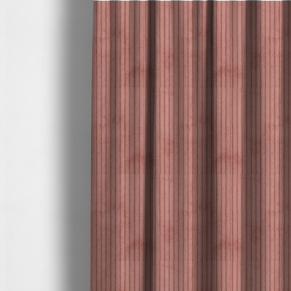 The fabric used to create these made-to-measure curtains is a muted rose or dusty terracotta corduroy featuring a consistent vertical ribbed texture.