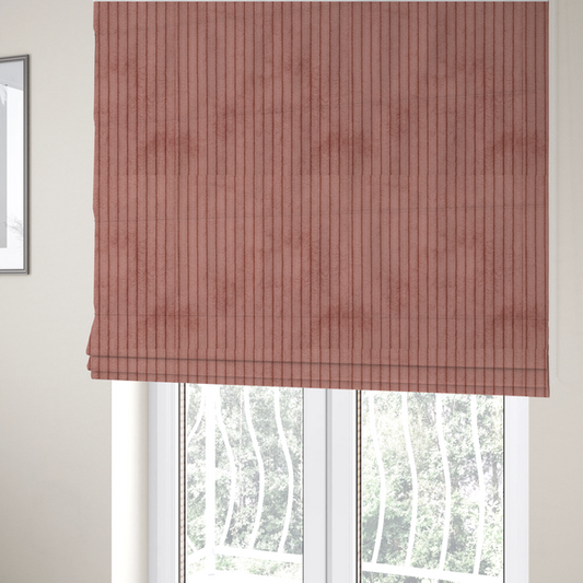 The fabric used to create these Roman blinds is a muted rose or dusty terracotta corduroy featuring a consistent vertical ribbed texture.