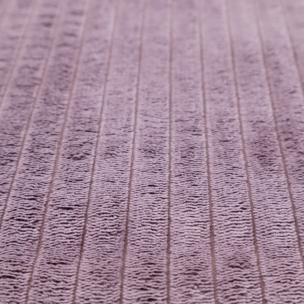 This fabric is a soft, dusty mauve or lavender-toned corduroy featuring a consistent vertical ribbed texture.
