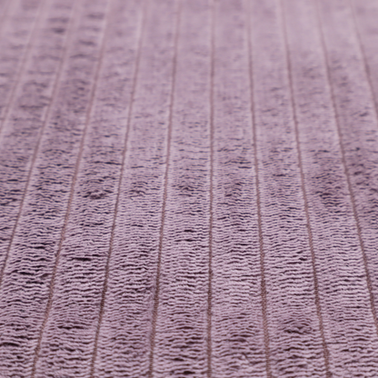 This fabric is a soft, dusty mauve or lavender-toned corduroy featuring a consistent vertical ribbed texture.
