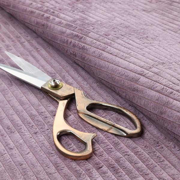 This fabric is a soft, dusty mauve or lavender-toned corduroy featuring a consistent vertical ribbed texture.