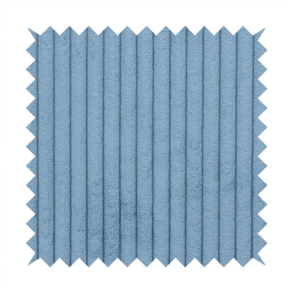 This fabric is a soft, dusty blue corduroy featuring a consistent vertical ribbed texture.