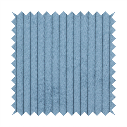 This fabric is a soft, dusty blue corduroy featuring a consistent vertical ribbed texture.