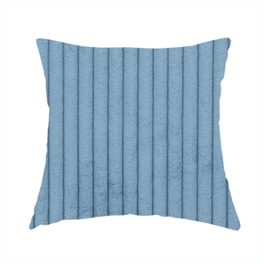 The fabric used to create these handmade cushions is a soft, dusty blue corduroy featuring a consistent vertical ribbed texture.