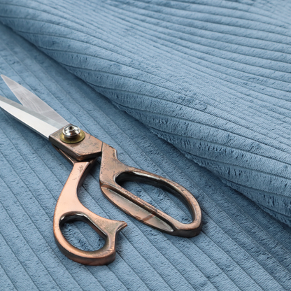 This fabric is a soft, dusty blue corduroy featuring a consistent vertical ribbed texture.
