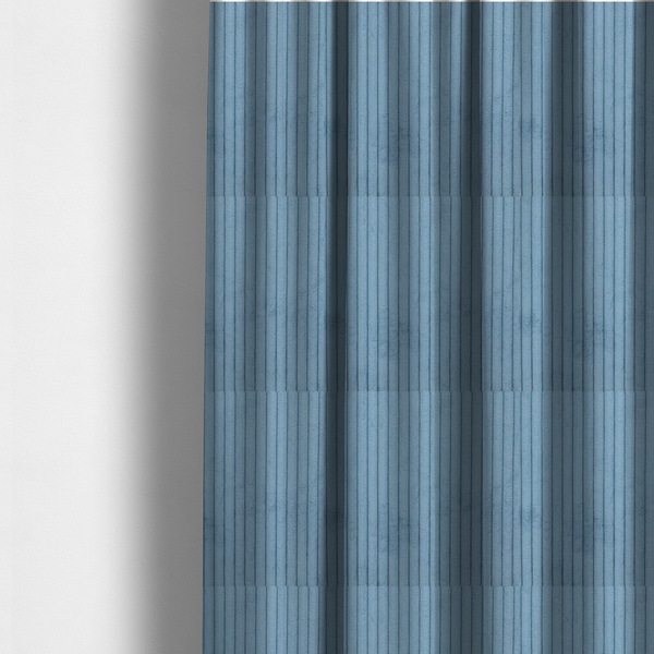 the fabric used to create these made-to-measure curtains is a soft, dusty blue corduroy featuring a consistent vertical ribbed texture.
