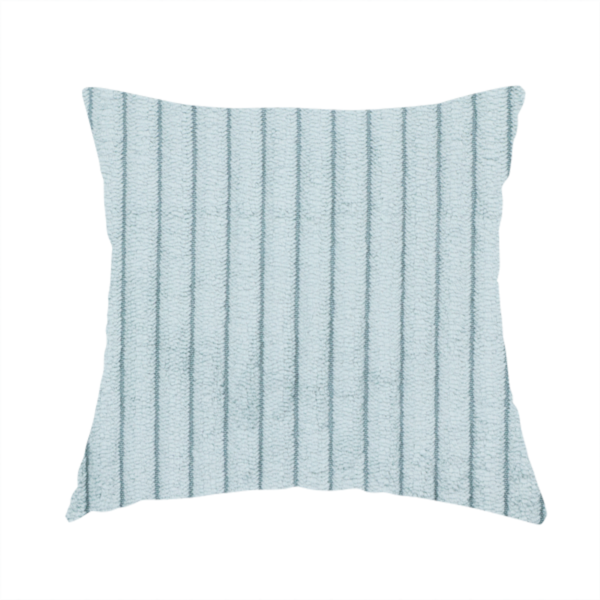 The fabric used to create this handmade cushion is a pale, icy blue corduroy featuring a consistent vertical ribbed texture.