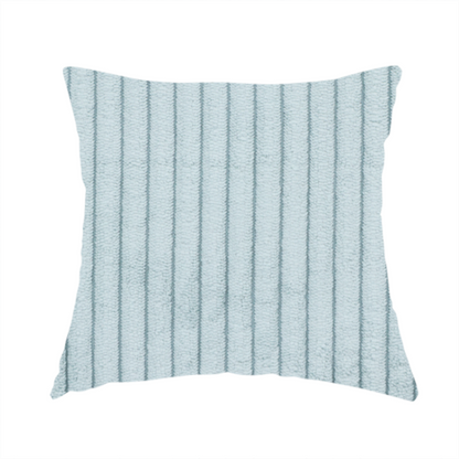 The fabric used to create this handmade cushion is a pale, icy blue corduroy featuring a consistent vertical ribbed texture.