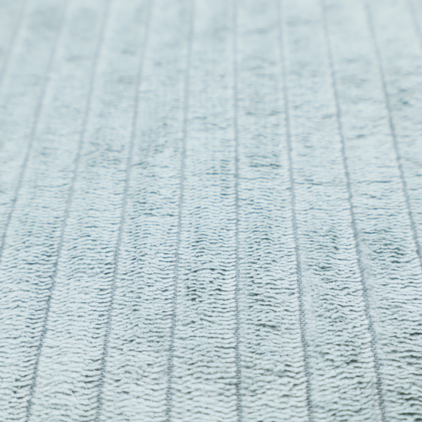 This fabric is a pale, icy blue corduroy featuring a consistent vertical ribbed texture.