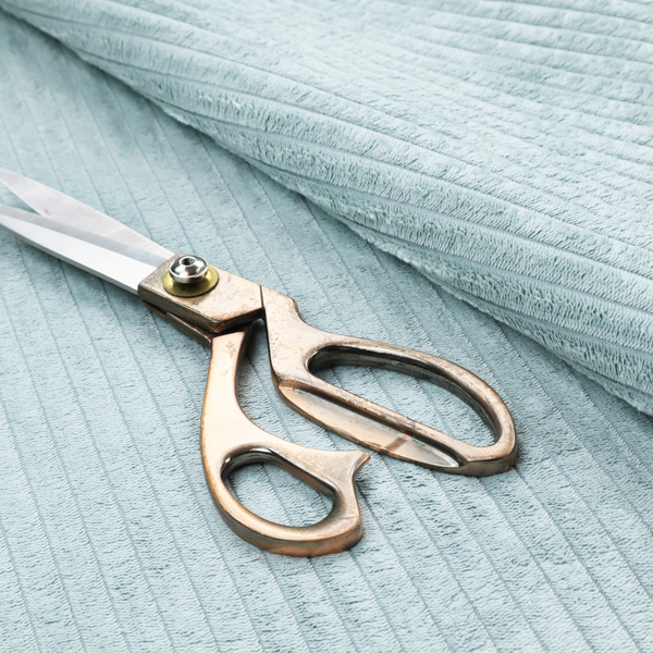 This fabric is a pale, icy blue corduroy featuring a consistent vertical ribbed texture.