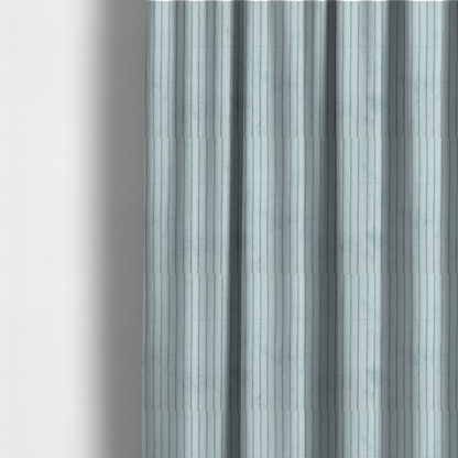 The fabric used to create these made-to-measure curtains is a pale, icy blue corduroy featuring a consistent vertical ribbed texture.