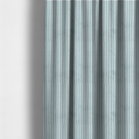 The fabric used to create these made-to-measure curtains is a pale, icy blue corduroy featuring a consistent vertical ribbed texture.