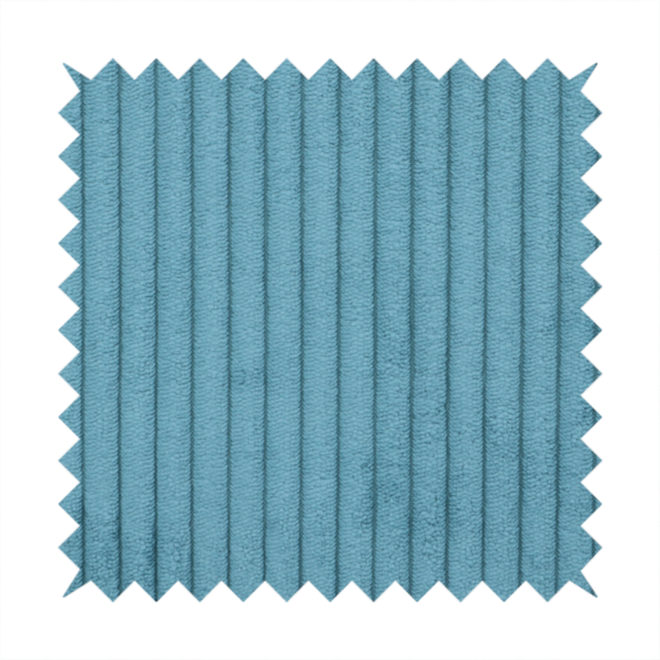 This fabric is a medium blue corduroy featuring a consistent vertical ribbed texture.
