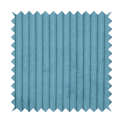 This fabric is a medium blue corduroy featuring a consistent vertical ribbed texture.