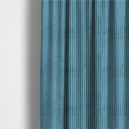 The fabric used to create these made-to-measure curtains is a medium blue corduroy featuring a consistent vertical ribbed texture.