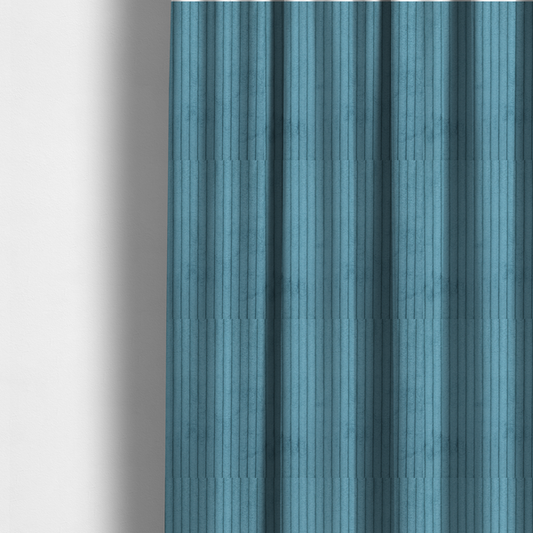The fabric used to create these made-to-measure curtains is a medium blue corduroy featuring a consistent vertical ribbed texture.