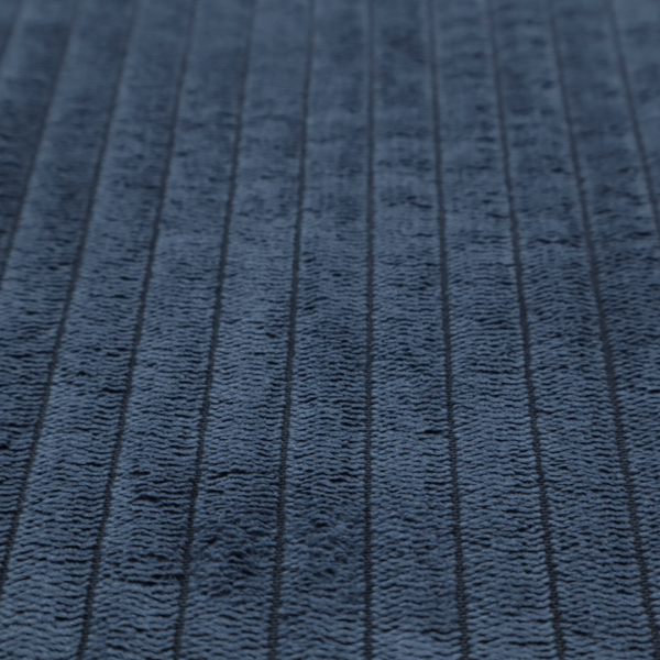 This fabric is a deep navy blue corduroy featuring a consistent vertical ribbed texture.