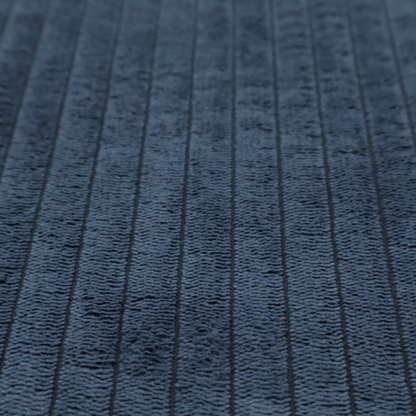 This fabric is a deep navy blue corduroy featuring a consistent vertical ribbed texture.