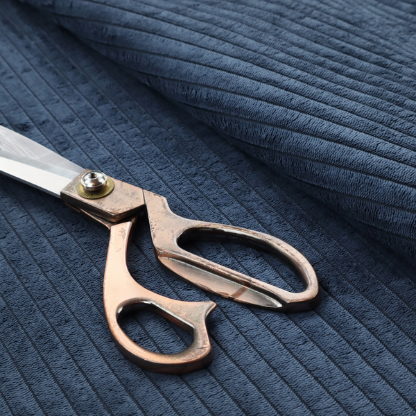 This fabric is a deep navy blue corduroy featuring a consistent vertical ribbed texture.