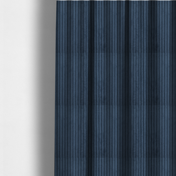 The fabric used to create these made-to-measure curtains is a deep navy blue corduroy featuring a consistent vertical ribbed texture.