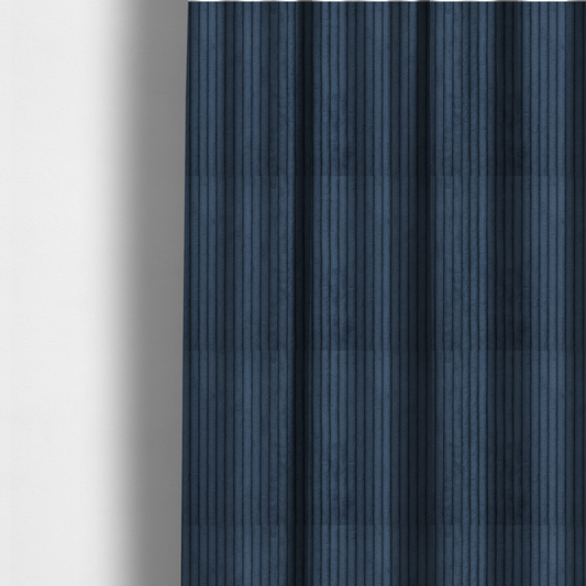 The fabric used to create these made-to-measure curtains is a deep navy blue corduroy featuring a consistent vertical ribbed texture.