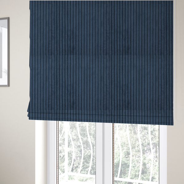 the fabric used to create these Roman blinds is a deep navy blue corduroy featuring a consistent vertical ribbed texture.
