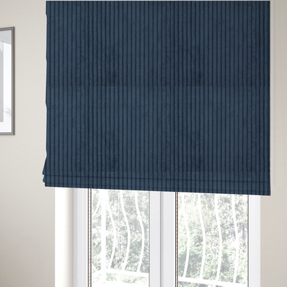 the fabric used to create these Roman blinds is a deep navy blue corduroy featuring a consistent vertical ribbed texture.