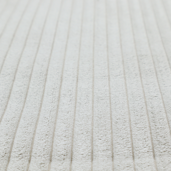This fabric is a light grey corduroy featuring a consistent vertical ribbed texture.