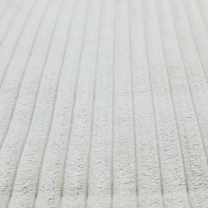 This fabric is a light grey corduroy featuring a consistent vertical ribbed texture.